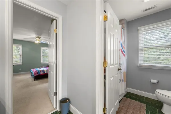 a bedroom with bed and window
