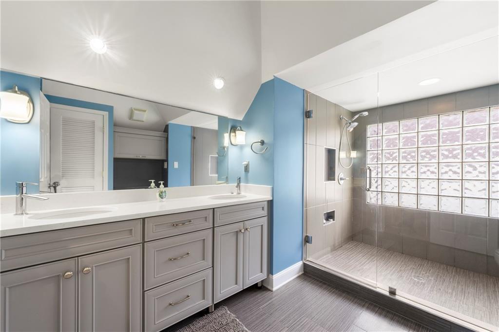 244 Dodgen Road Hampton, GA 30228 - Photo 40 of 55 a spacious bathroom with a double vanity sink large mirror and a bathtub