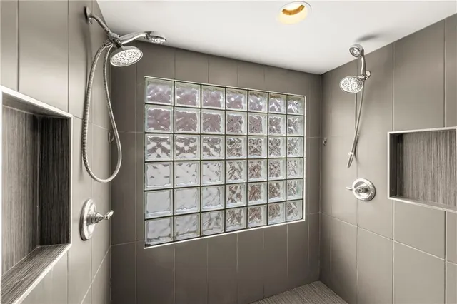 a living room with furniture a ceiling fan and a rug