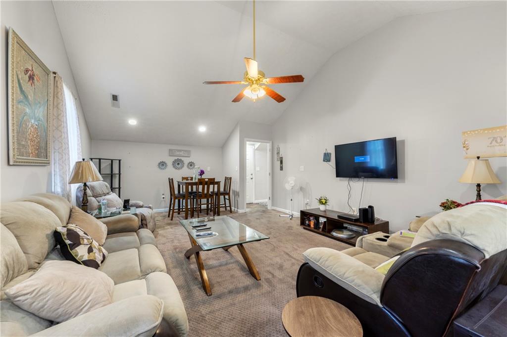 244 Dodgen Road Hampton, GA 30228 - Photo 46 of 55 a living room with furniture a ceiling fan and a rug