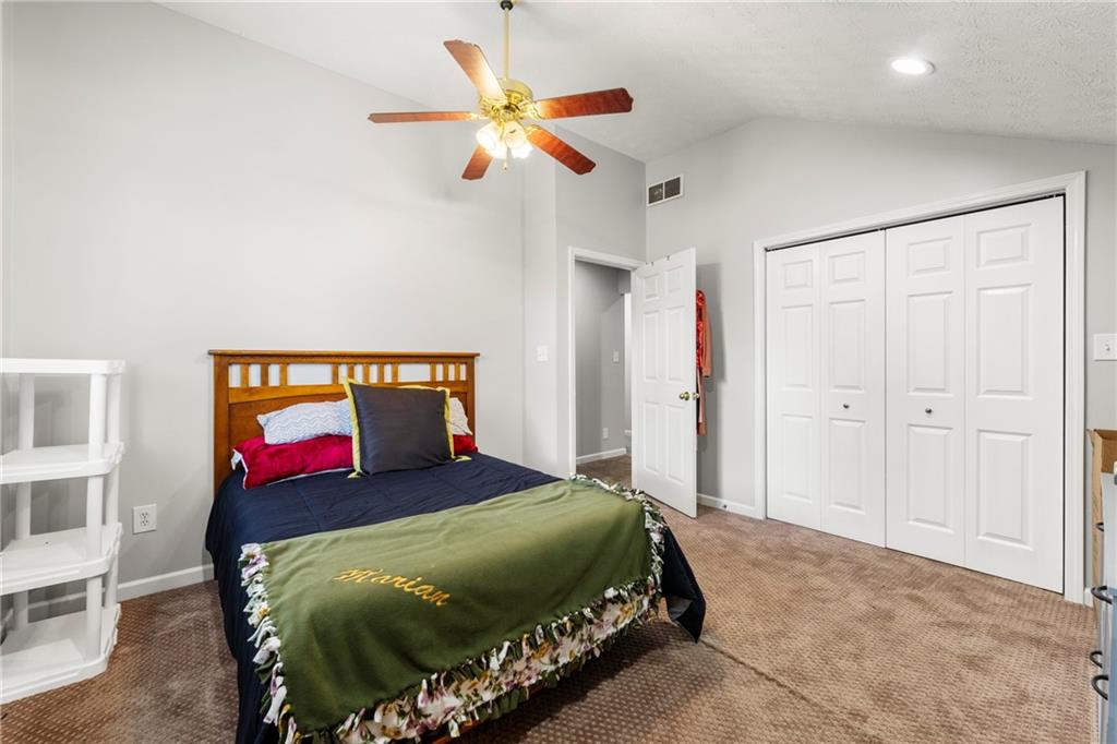 244 Dodgen Road Hampton, GA 30228 - Photo 50 of 55 a bedroom with a bed and a chandelier