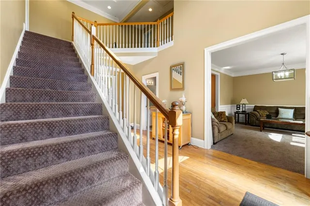 a view of hallway with stairs and wooden floor