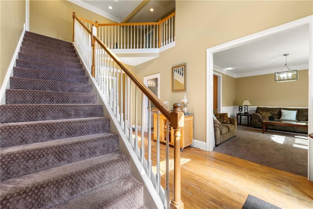 244 Dodgen Road Hampton, GA 30228 - Photo 5 of 55 a view of staircase with lots of frames on wall and a dining table
