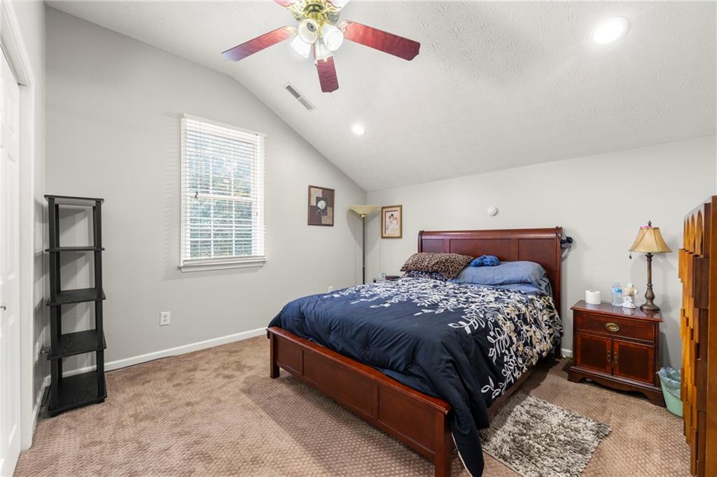 244 Dodgen Road Hampton, GA 30228 - Photo 51 of 55 a bedroom with a bed and a chandelier