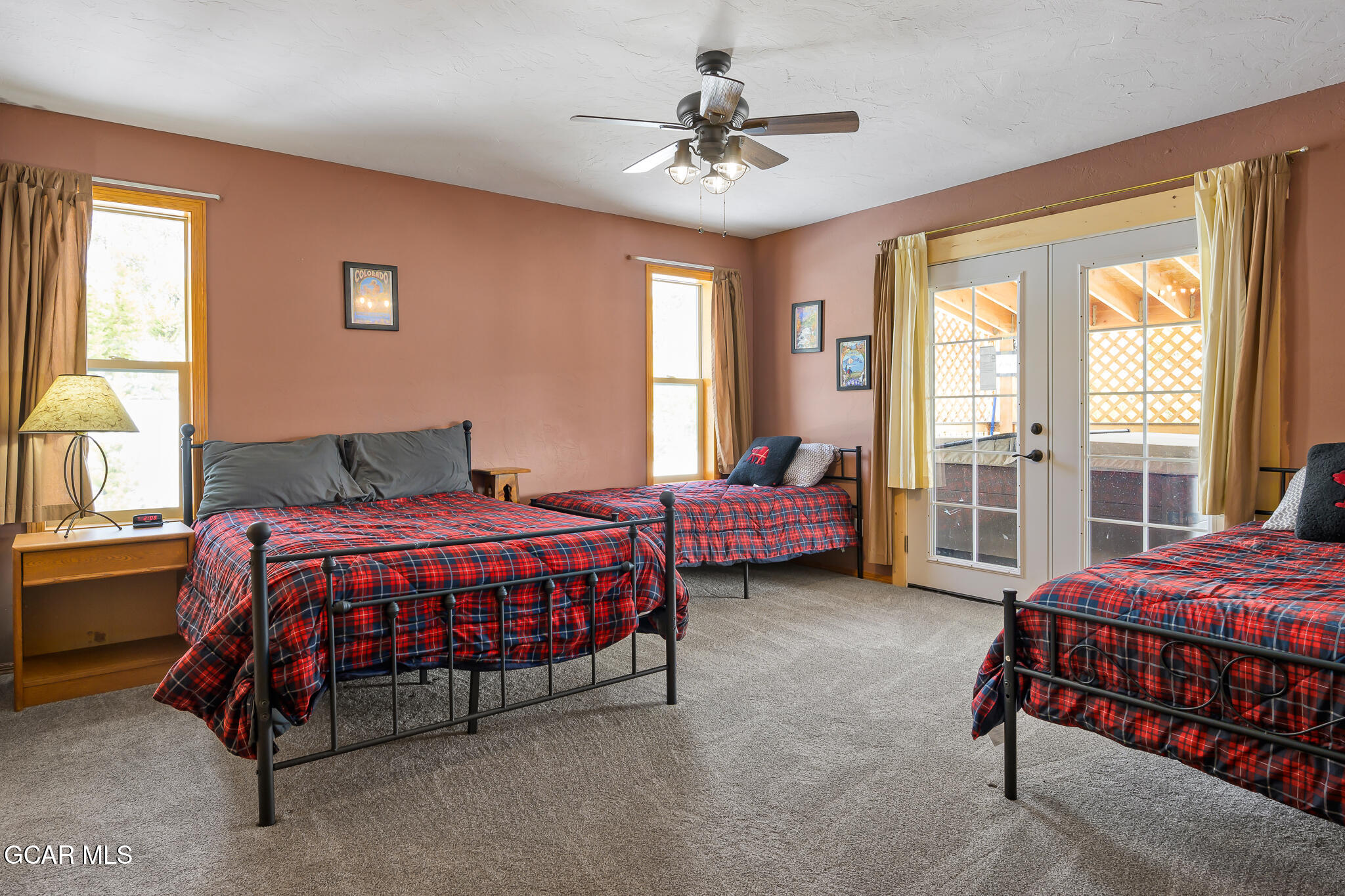 300 County Road Grand Lake, CO 80447 - Photo 19 of 47 a spacious bedroom with a bed and a chandelier