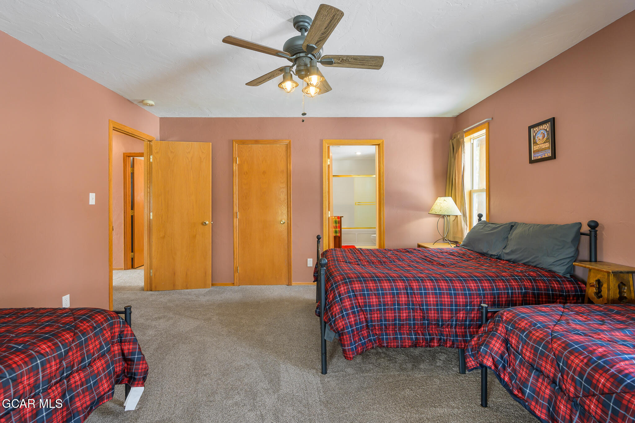 300 County Road Grand Lake, CO 80447 - Photo 20 of 47 a bedroom with two beds and a chandelier