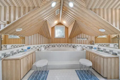 a bathroom with a granite countertop sink a toilet and shower