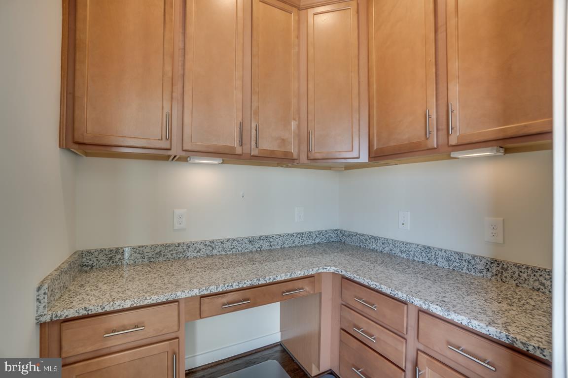 19958 Abram Terrace Ashburn, VA 20147 - Photo 13 of 41 a kitchen with granite countertop cabinets and white appliances