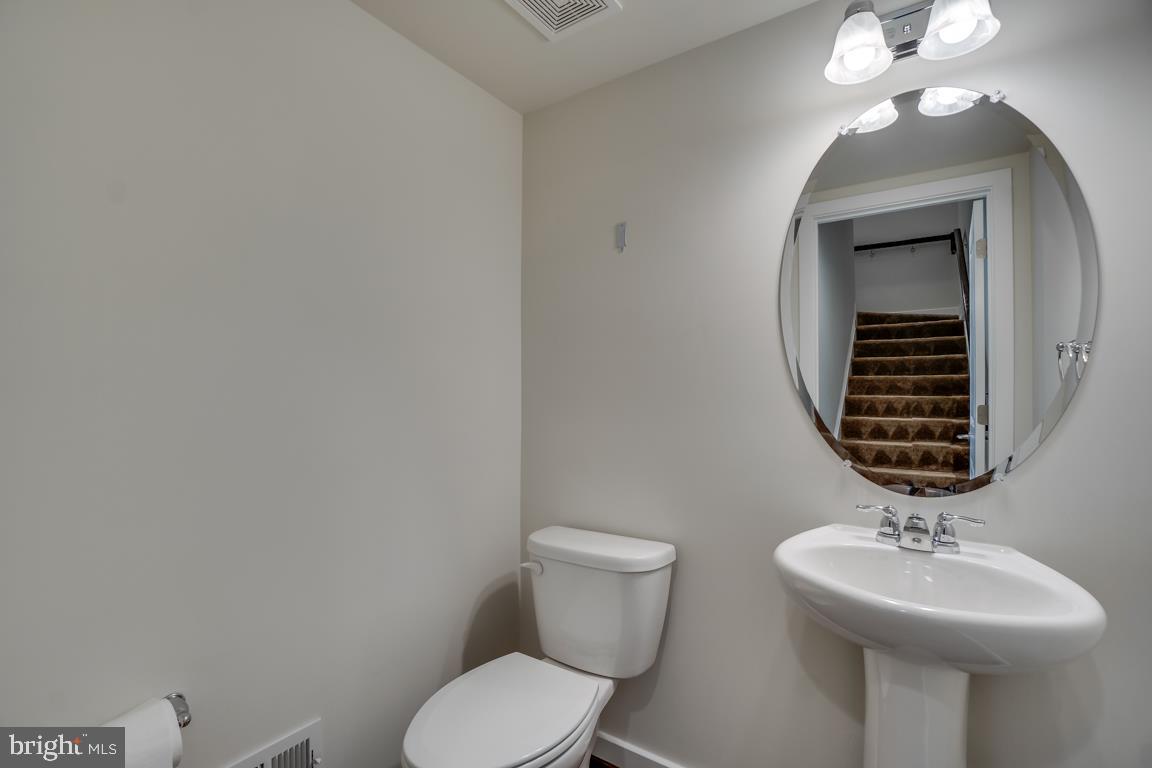 19958 Abram Terrace Ashburn, VA 20147 - Photo 14 of 41 a bathroom with a toilet a sink and mirror