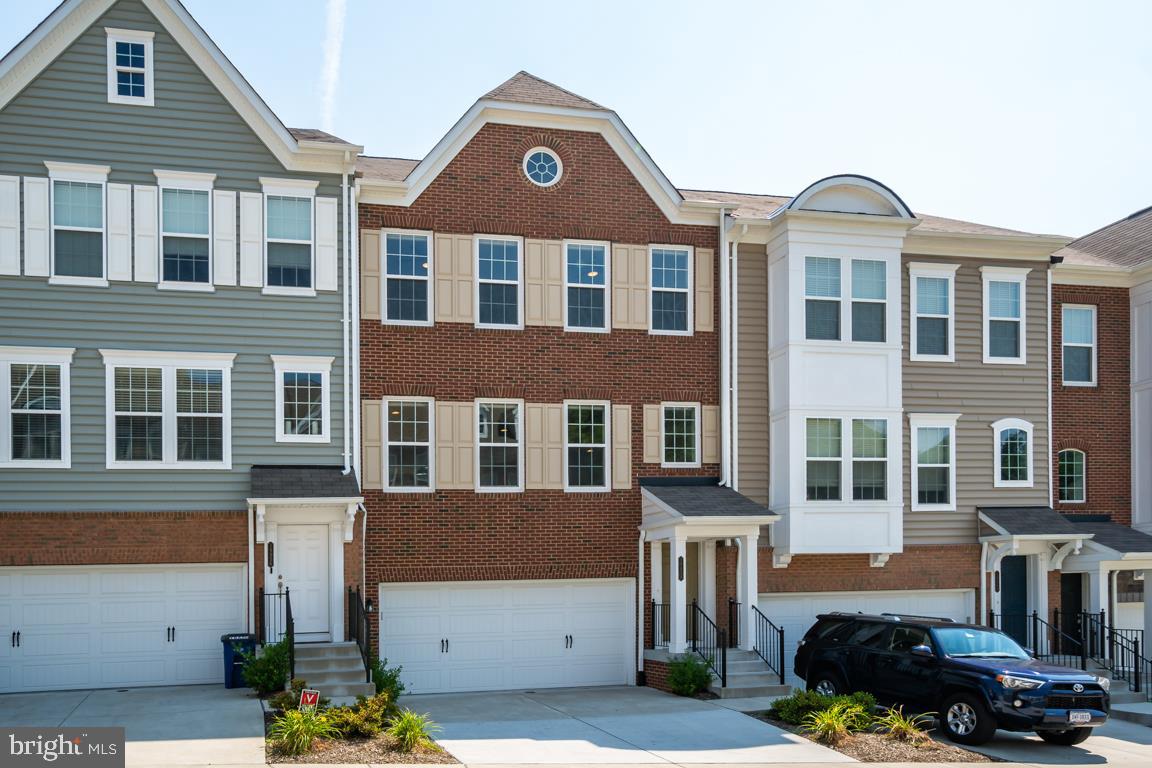 19958 Abram Terrace Ashburn, VA 20147 - Photo 2 of 41 a front view of a residential apartment building with a yard
