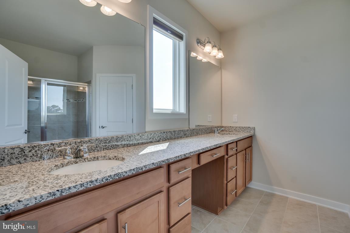 19958 Abram Terrace Ashburn, VA 20147 - Photo 22 of 41 a bathroom with a granite countertop sink and a mirror