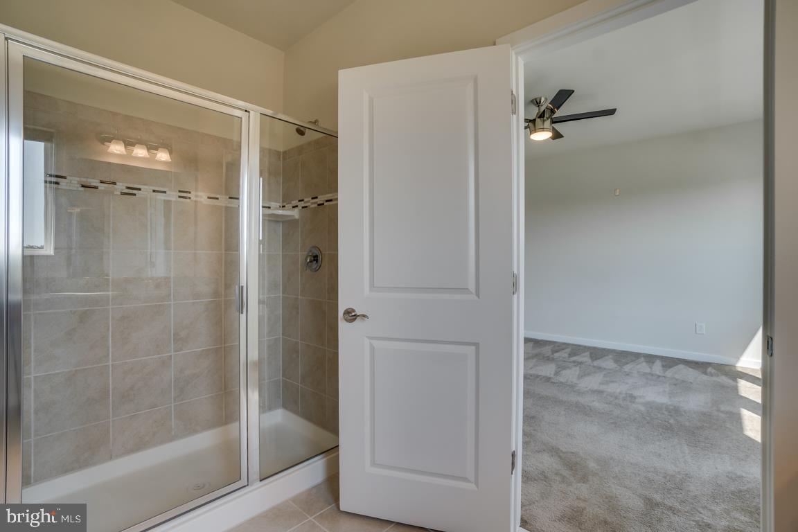 19958 Abram Terrace Ashburn, VA 20147 - Photo 23 of 41 a bathroom with a glass shower door
