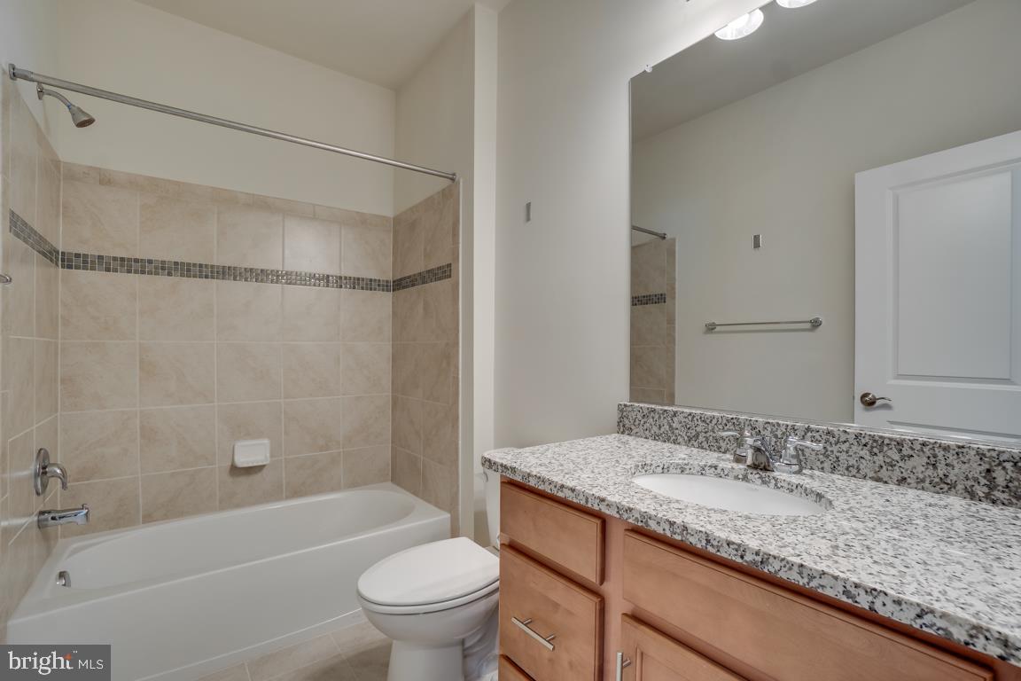 19958 Abram Terrace Ashburn, VA 20147 - Photo 24 of 41 a bathroom with a granite countertop sink toilet and shower