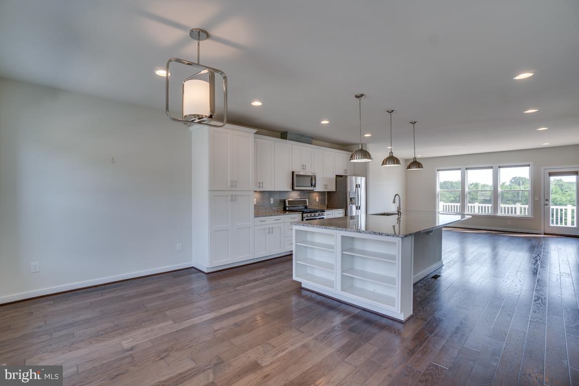 19958 Abram Terrace Ashburn, VA 20147 - Photo 3 of 41 a view of kitchen with sink microwave and wooden floor