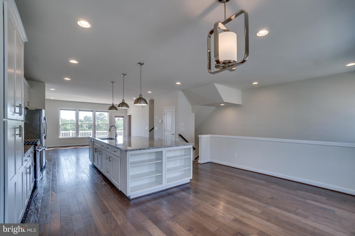 19958 Abram Terrace Ashburn, VA 20147 - Photo 4 of 41 a living room with kitchen island furniture and a wooden floor