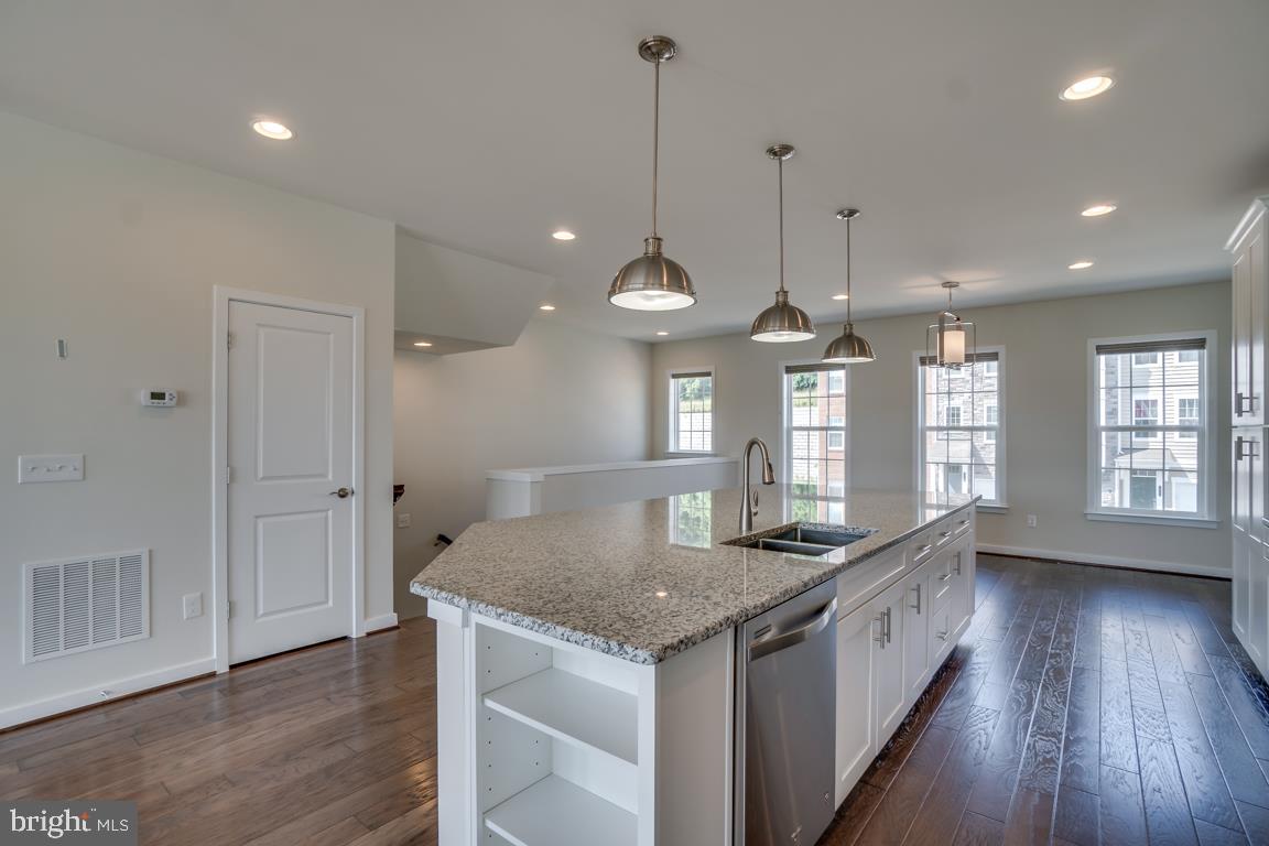 19958 Abram Terrace Ashburn, VA 20147 - Photo 7 of 41 a kitchen with granite countertop a sink a counter space and a window