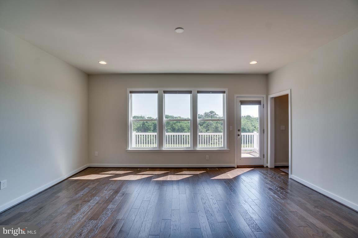19958 Abram Terrace Ashburn, VA 20147 - Photo 9 of 41 a view of an empty room with wooden floor and a window
