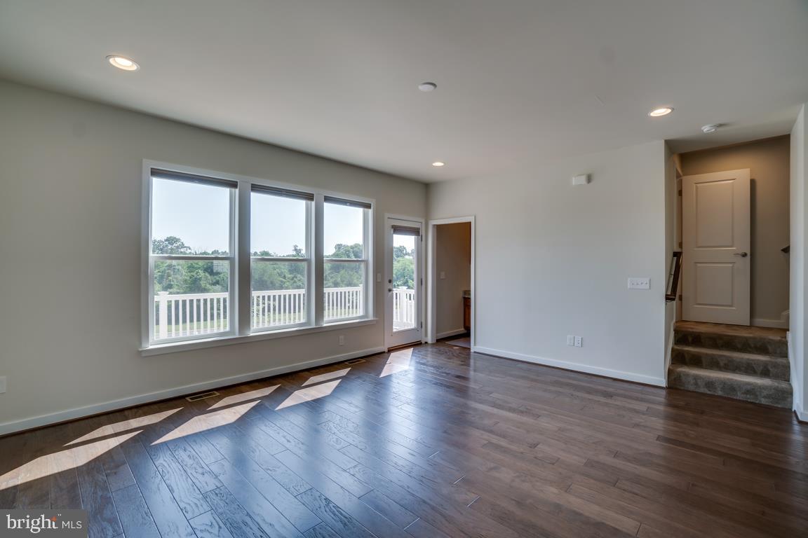 19958 Abram Terrace Ashburn, VA 20147 - Photo 10 of 41 a view of an empty room with wooden floor and a window