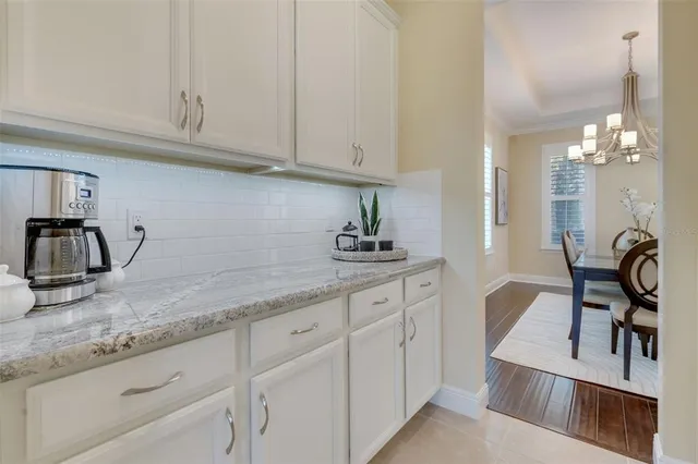 a view of a dining room with furniture and chandelier