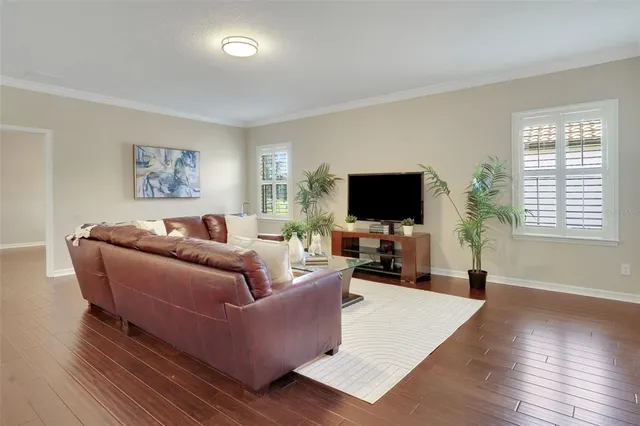 a living room with furniture and wooden floor