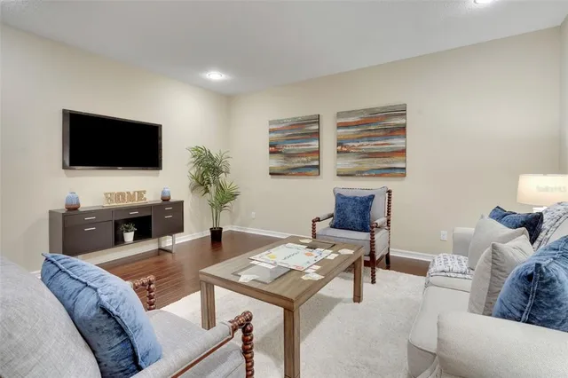 a living room with furniture and wooden floor