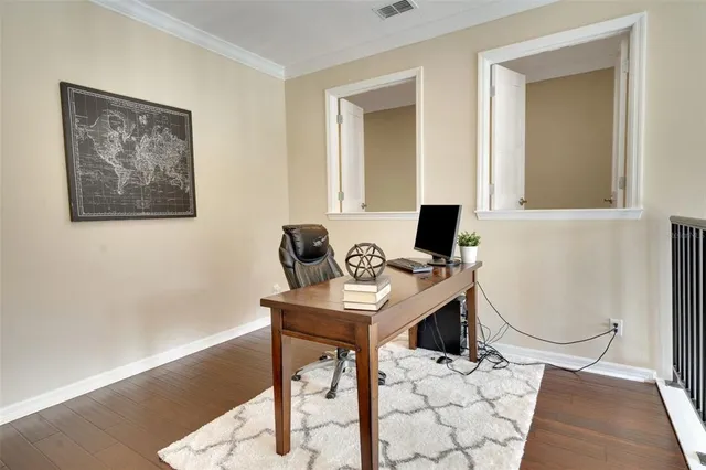 a view of a workspace with furniture and a window