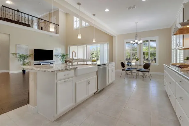 a dining room with furniture a large window and stainless steel appliances