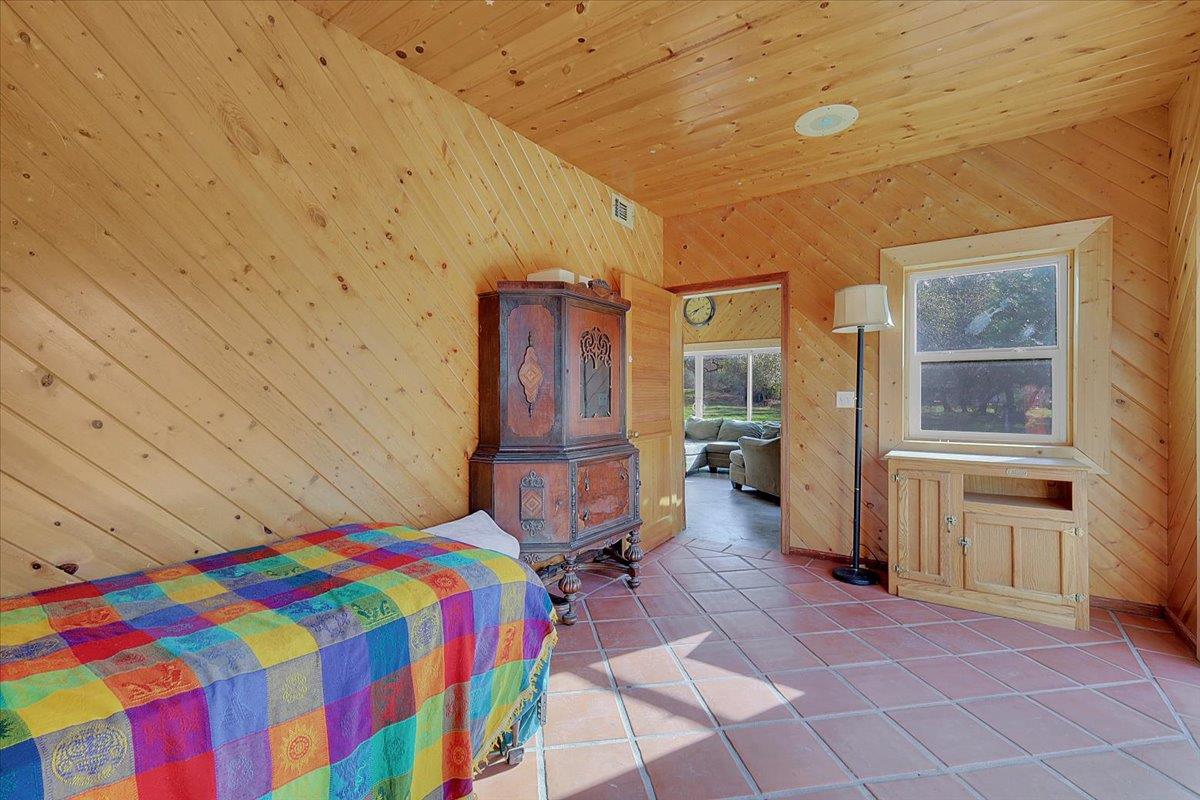 13980 Mountain House Road Penn Valley, CA 95946 - Photo 16 of 58 a bedroom with a bed and wooden floor