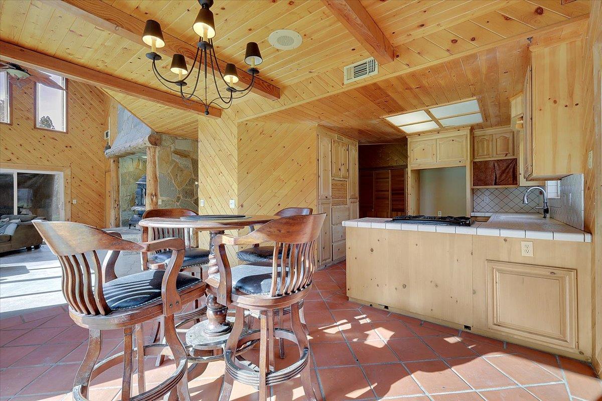 13980 Mountain House Road Penn Valley, CA 95946 - Photo 18 of 58 a view of a dining room with furniture and a chandelier