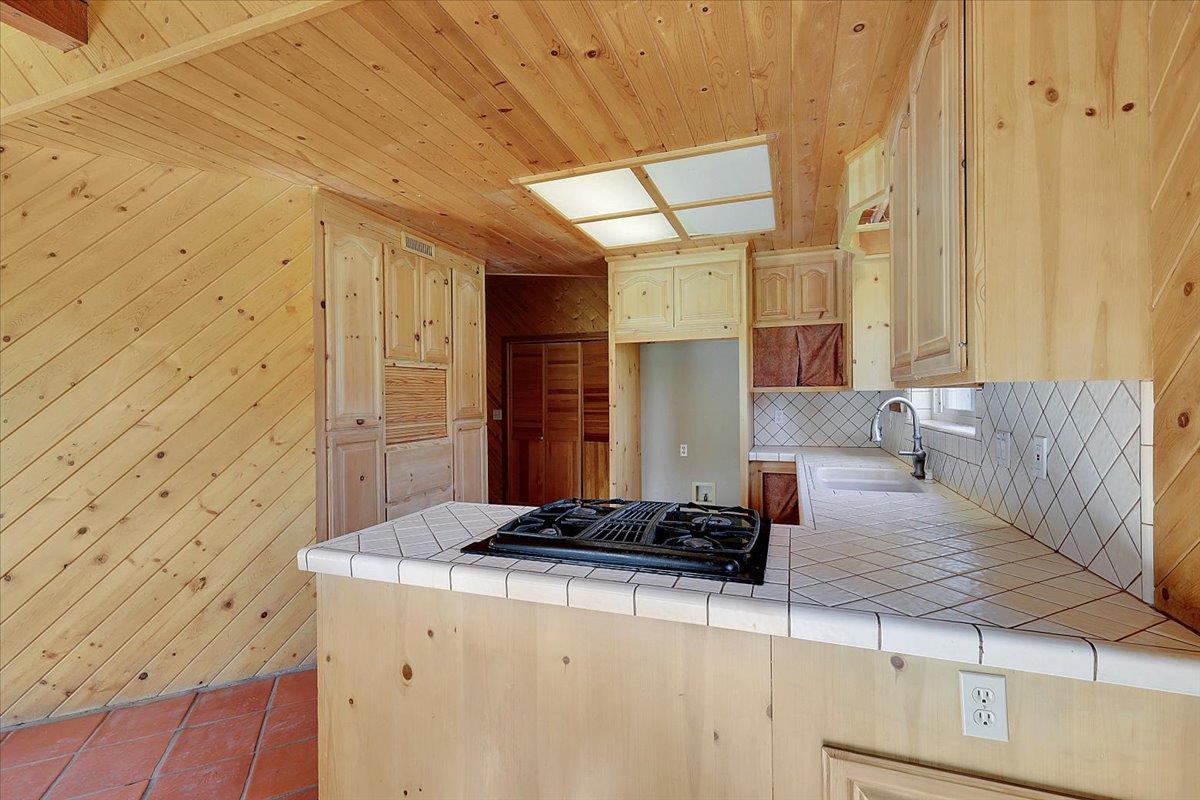 13980 Mountain House Road Penn Valley, CA 95946 - Photo 19 of 58 a bathroom with a granite countertop sink and a mirror