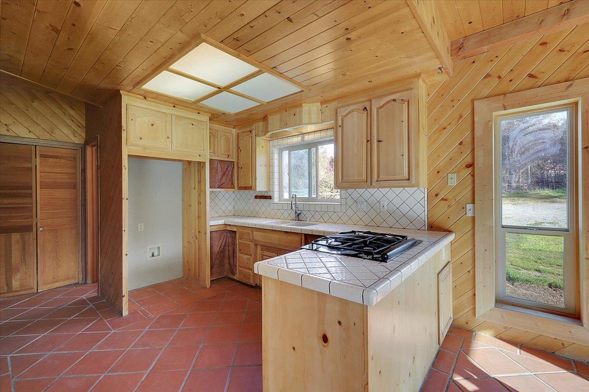 13980 Mountain House Road Penn Valley, CA 95946 - Photo 20 of 58 a kitchen that has a lot of cabinets in it