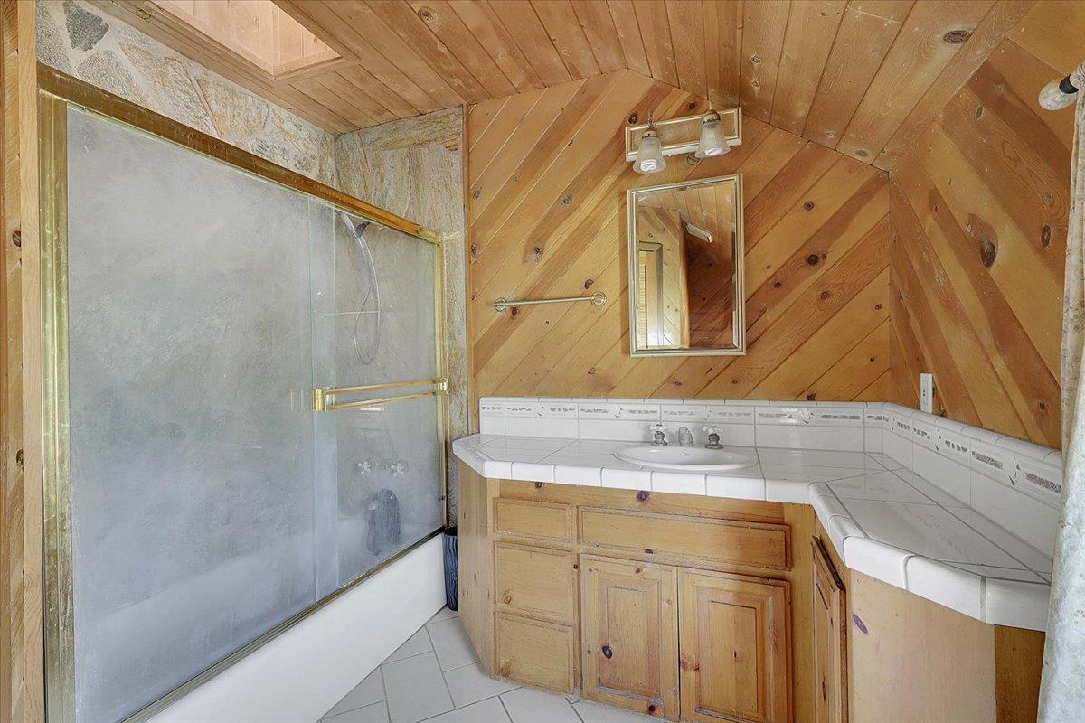 13980 Mountain House Road Penn Valley, CA 95946 - Photo 27 of 58 a bathroom with a sink and a mirror