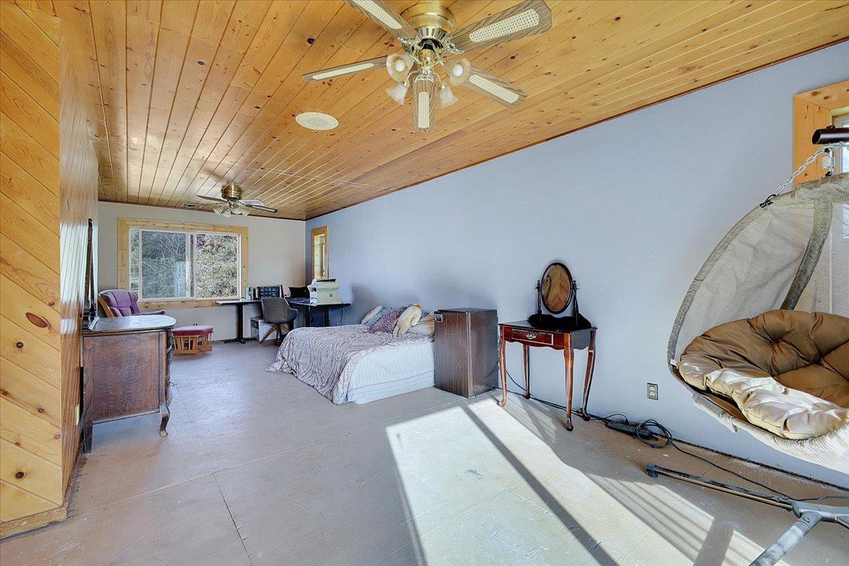 13980 Mountain House Road Penn Valley, CA 95946 - Photo 32 of 58 a living room with furniture and a chandelier