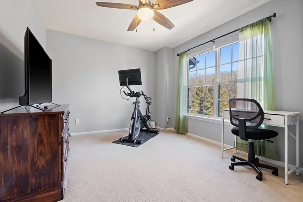 a view of a workspace with furniture and a window