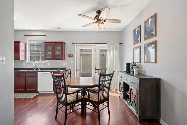 a view of a dining room with furniture and wooden floor