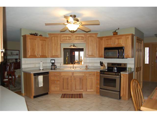11920 North Adeline Road German Valley, IL 61039 - Photo 8 of 9 a kitchen with kitchen island granite countertop a stove top oven a sink and dishwasher