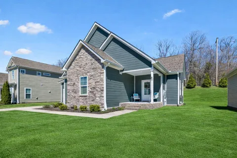 a front view of house with a garden and yard