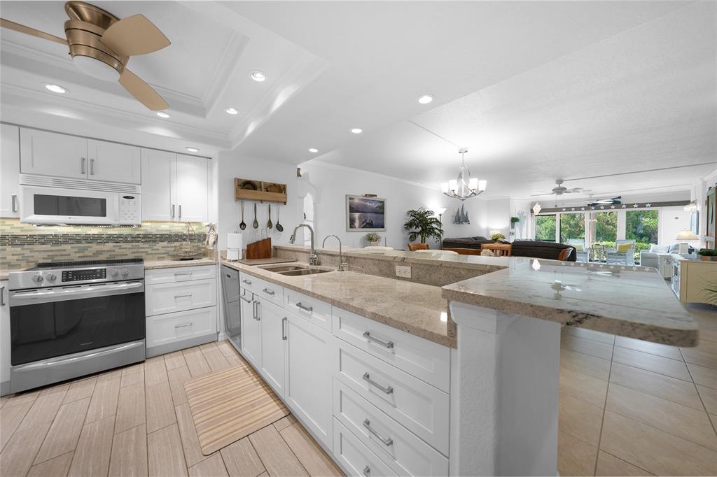 601 Shreve Street, Unit 16A Punta Gorda, FL 33950 - Photo 11 of 52 a kitchen with stainless steel appliances granite countertop a sink and cabinets