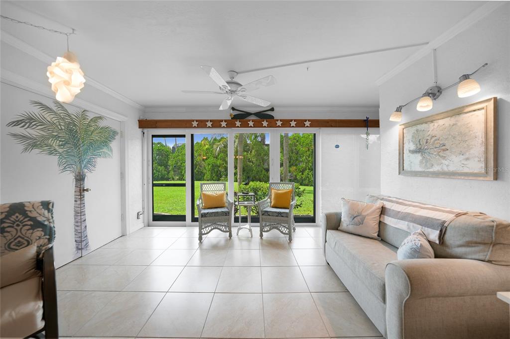 601 Shreve Street, Unit 16A Punta Gorda, FL 33950 - Photo 13 of 52 a living room with furniture a chandelier and a large window