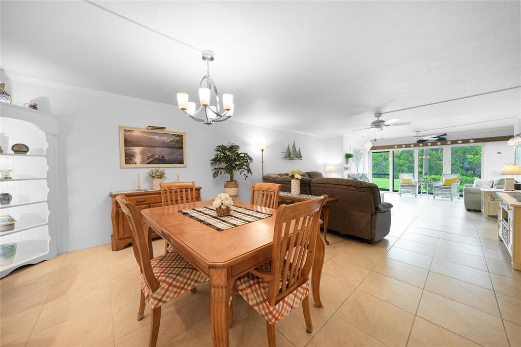 601 Shreve Street, Unit 16A Punta Gorda, FL 33950 - Photo 19 of 52 a view of a dining room with furniture a chandelier and a window