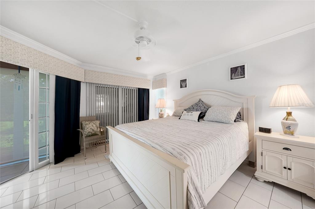 601 Shreve Street, Unit 16A Punta Gorda, FL 33950 - Photo 21 of 52 a bedroom with a bed and a lamp