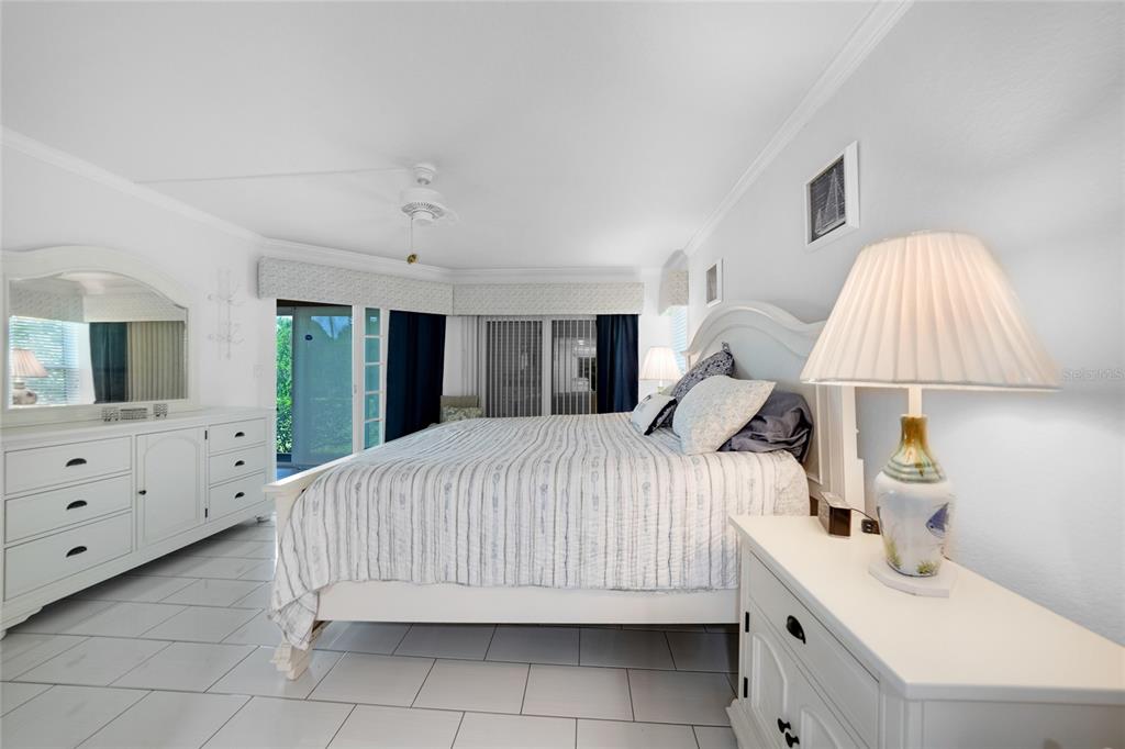 601 Shreve Street, Unit 16A Punta Gorda, FL 33950 - Photo 22 of 52 a bedroom with a bed and a baby bed