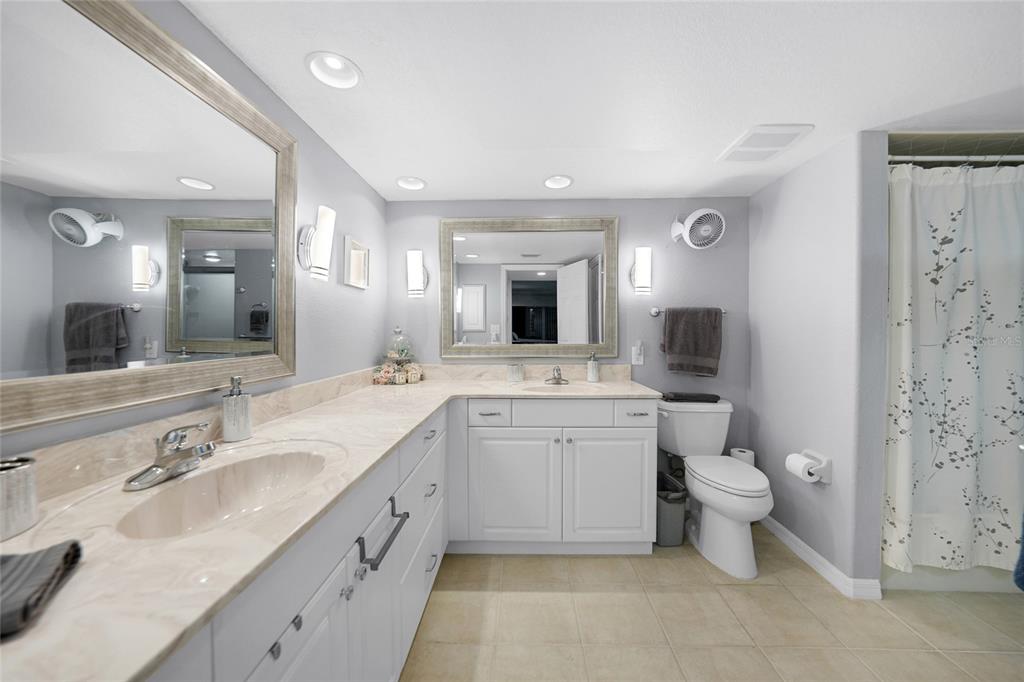 601 Shreve Street, Unit 16A Punta Gorda, FL 33950 - Photo 24 of 52 a spacious bathroom with a double vanity sink toilet and a mirror
