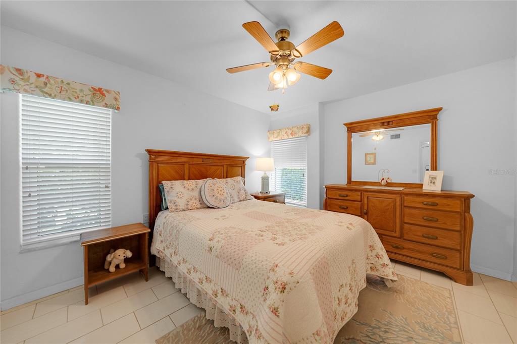 601 Shreve Street, Unit 16A Punta Gorda, FL 33950 - Photo 28 of 52 a bedroom with a bed and a chandelier