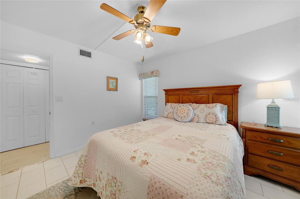601 Shreve Street, Unit 16A Punta Gorda, FL 33950 - Photo 29 of 52 a bedroom with a bed and a chandelier