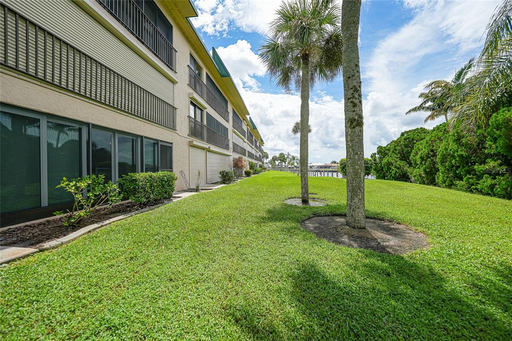 601 Shreve Street, Unit 16A Punta Gorda, FL 33950 - Photo 35 of 52 a view of a house with a yard and palm trees