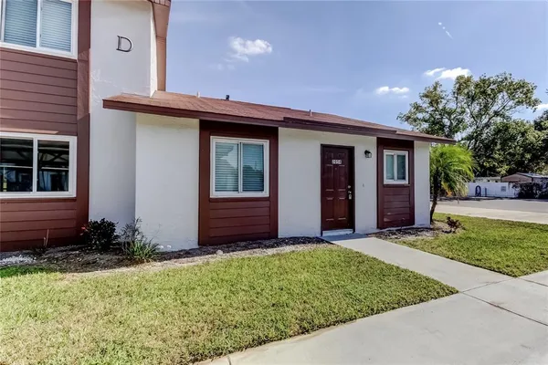 a view of a house with a small yard and plants