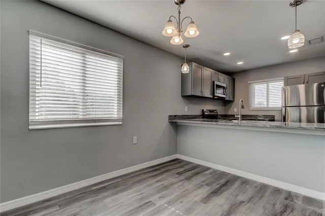 a view of kitchen with granite countertop cabinets a sink and dishwasher