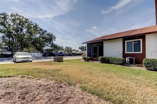 a view of a house with backyard and porch