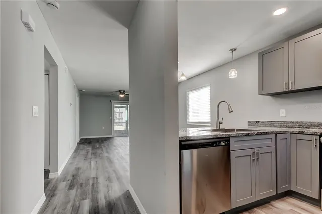 a kitchen with cabinets appliances and a sink